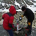 Kym demonstrates a remotely operated penguin nest camera. The camera is mounted on a tripod, weighed down with rocks, and sheltered from the worst of the weather inside Pelican cases.