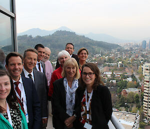 The Australian delegation to the Treaty meeting on a hotel balcony with a city backdrop.