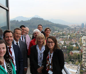 The Australian delegation to the Treaty meeting on a hotel balcony with a city backdrop