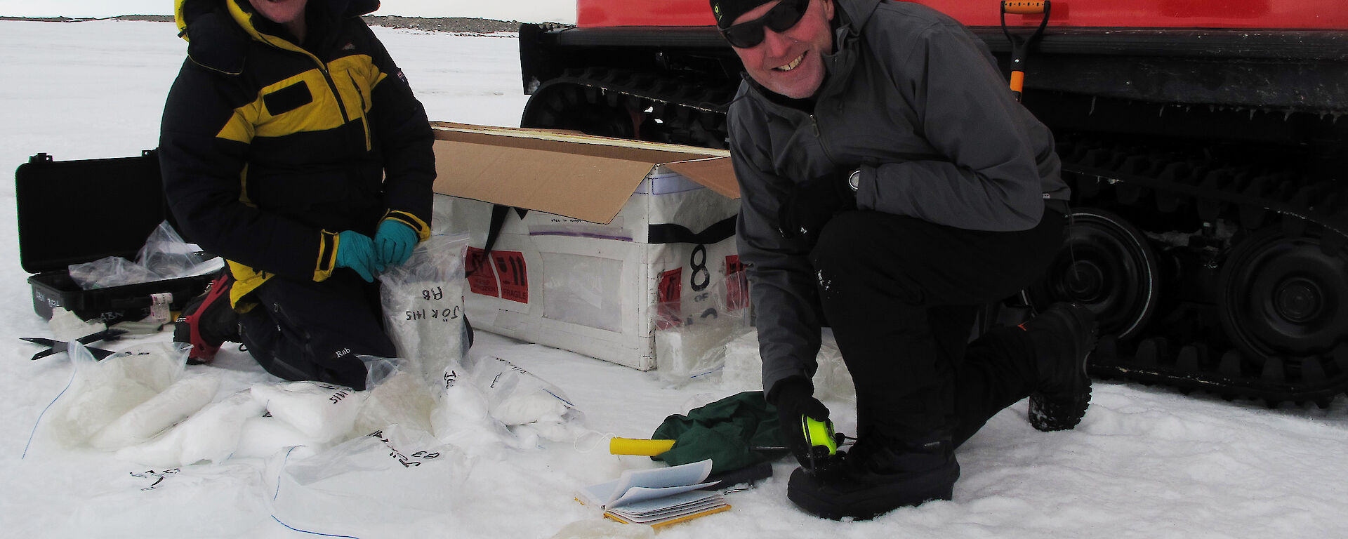 Dr David Etheridge and Dr Andrew Smith take samples of the rare sub-glacial water eruption for analysis