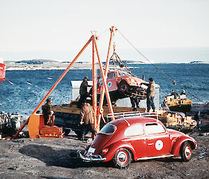 The ‘Antarctica 2’ VW car is unloaded from the Nella Dan while ‘Antarctica 1’ waits to be loaded for its journey back to Australia