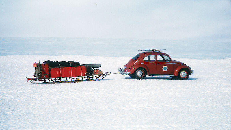 The Ruby-Red Antarctica 1 VW car towing a sled across the snow