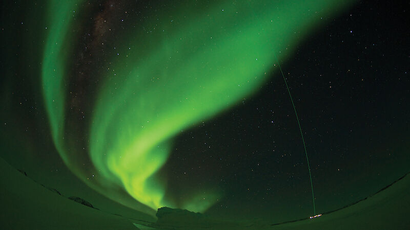 A spectacular green aurora is intersected by the LIDAR (light detection and ranging) laser beam at Davis station