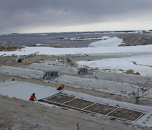 During construction of biopile 6, a geotextile is rolled out over a protective soil layer and the PVC pipes of the aeration system.