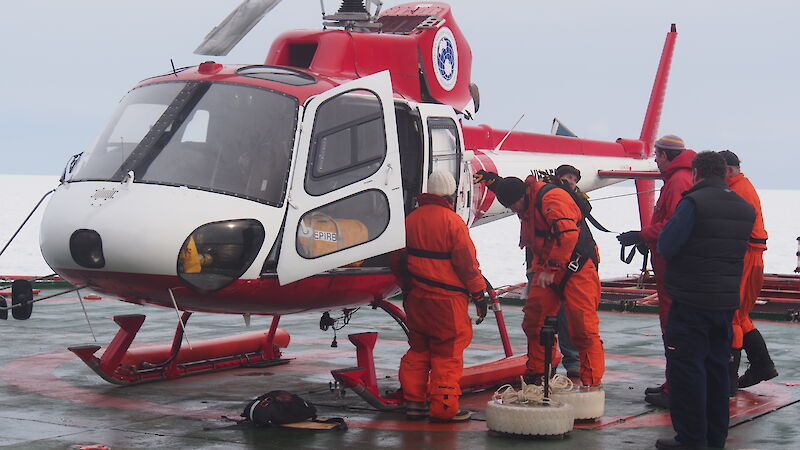 Dr Alison Kohout (left) prepares to deploy wave sensors on ice floes deep in the Marginal Ice Zone, accessible only by helicopter.