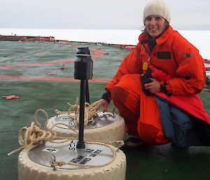 Dr Alison Kohout with two of her wave sensors on the stern of the Aurora Australis during the Sea Ice Physics and Ecosystem eXperiment (SIPEX-II) voyage in September 2012.