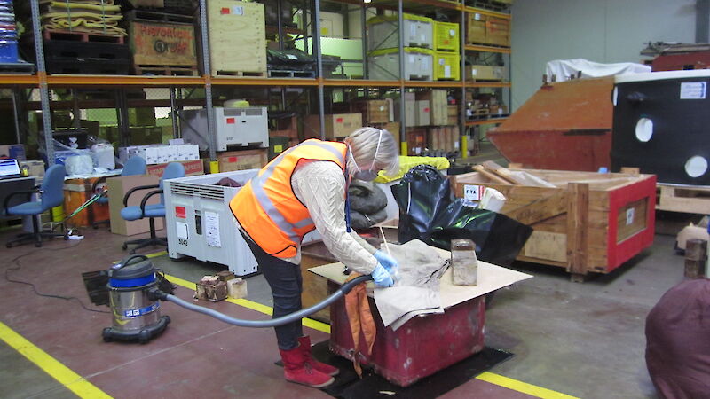 Linda Clark cleans artefacts in the warehouse.