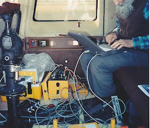Roger Handsworth installs the Zeiss camera in a helicopter in Victoria in 1993. The tall, black tube on the left is a World War II bomb sight, used to see the terrain being travelled over and to correct the camera angle to accommodate helicopter drift.