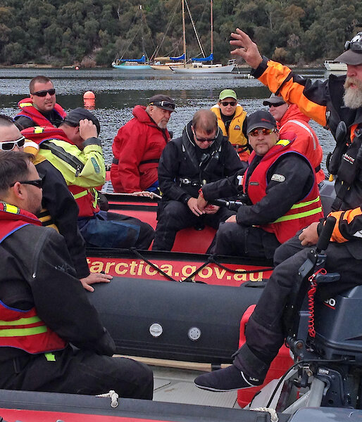 Australian Antarctic Division Watercraft Operator, Mick Davidson (right) explains the unique characteristics of boating in Antarctica