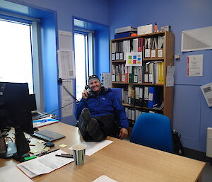 Steve with his feet up on his desk.