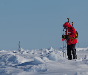 Dr Ted Maksym on the sea ice using a snow probe to measure snow depth and ice surface topography