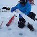 Ken uses a lasso to help extract an ice core from the sea ice