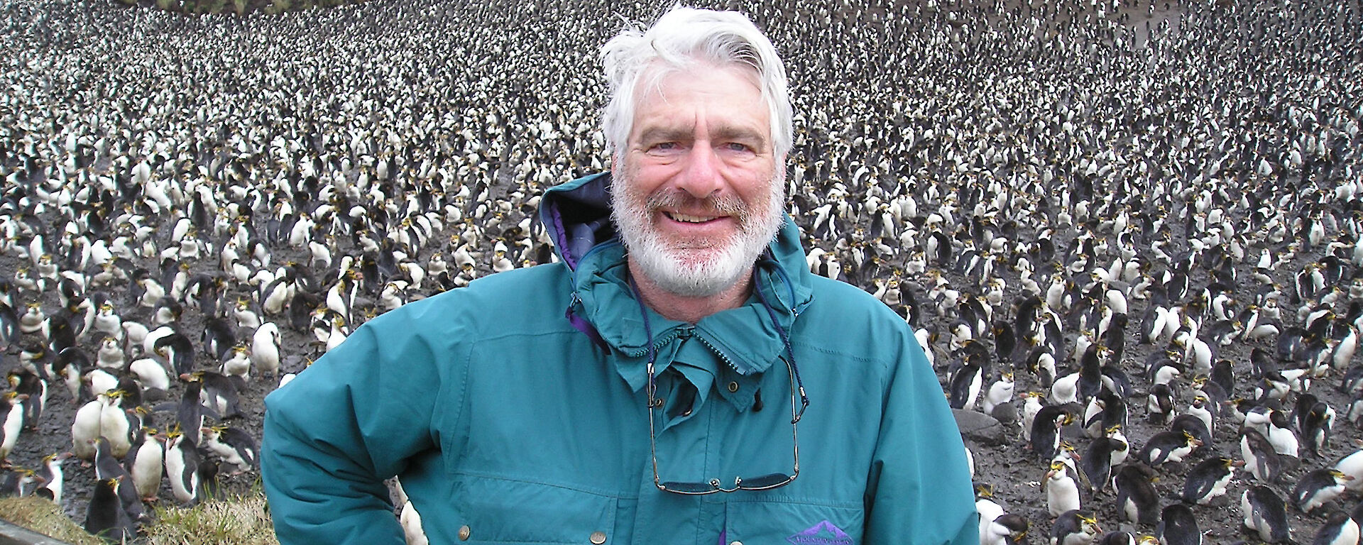 Don standing in front of a penguin colony on Macquarie Island