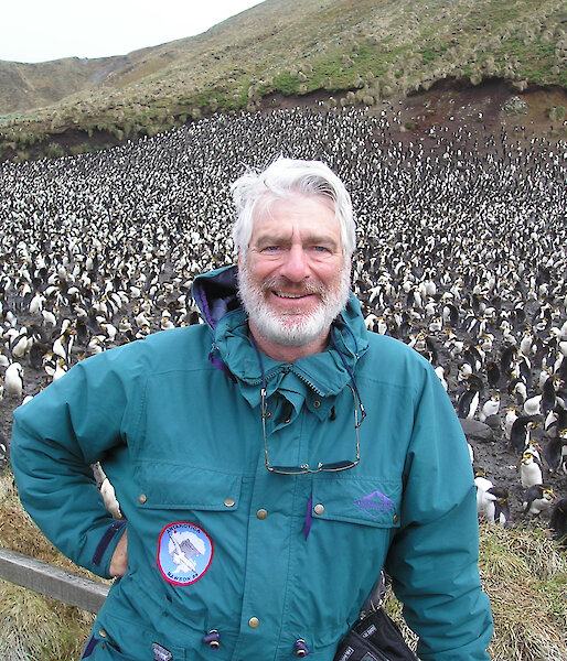 Don standing in front of a penguin colony on Macquarie Island