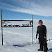 Lyn Maddock standing near a sign in Antarctica