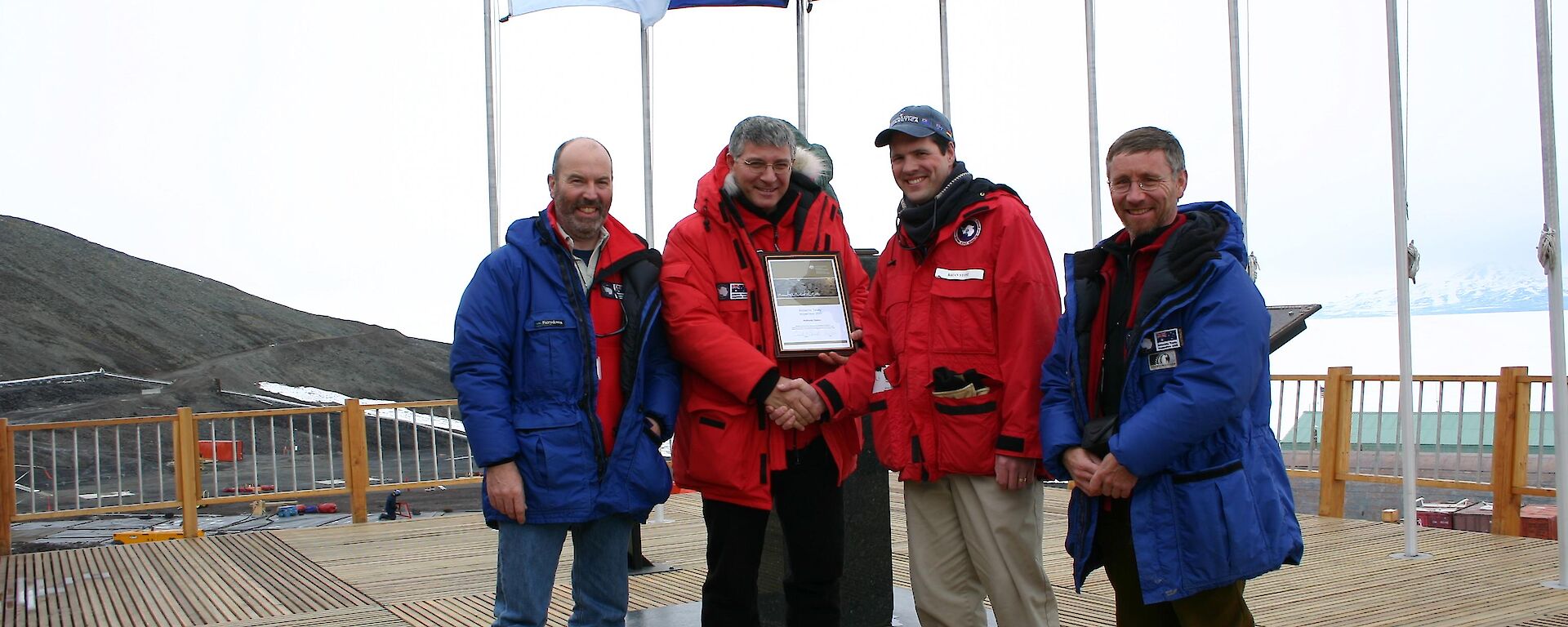 The observer team making a presentation to Brian Stone (3rd from left), the Senior Representative of the National Science Foundation, at the conclusion of the inspection of McMurdo Station.