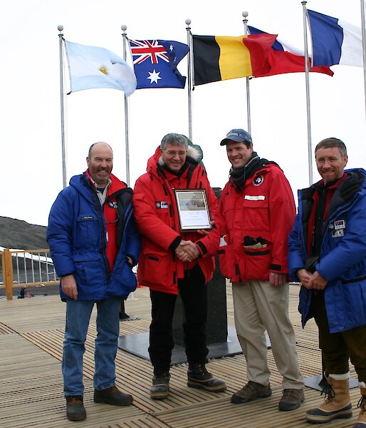 The observer team making a presentation to Brian Stone (3rd from left), the Senior Representative of the National Science Foundation, at the conclusion of the inspection of McMurdo Station.