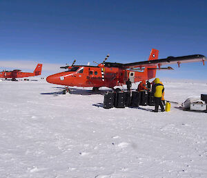 Two British Antarctic Survey aircraft being loaded with scientific equipment