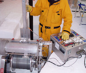 A scientist monitors an ice core drill at Law Dome in 2004.=