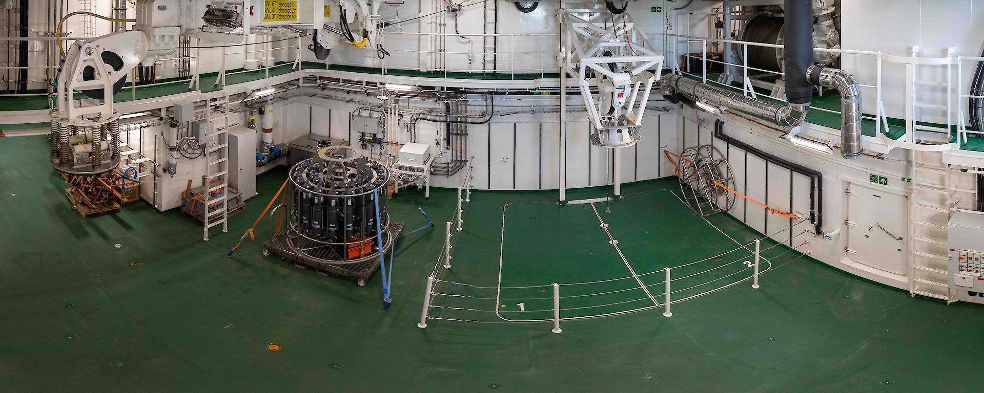 Wide angle view of the moon pool room with a CTD tied to the deck.