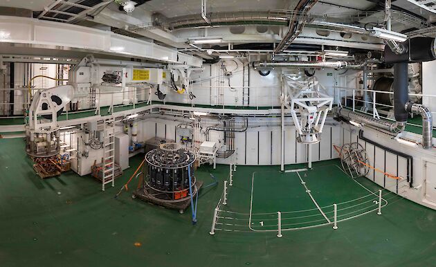 Wide angle view of the moon pool room with a CTD tied to the deck.