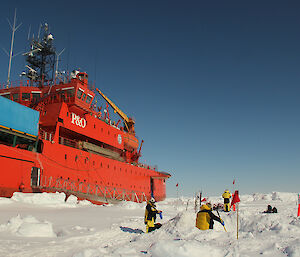 Scientists collecting samples on the sea ice, beside the Aurora Australis.