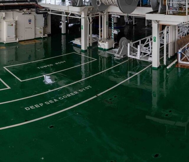A deck on a ship filled with white equipment.