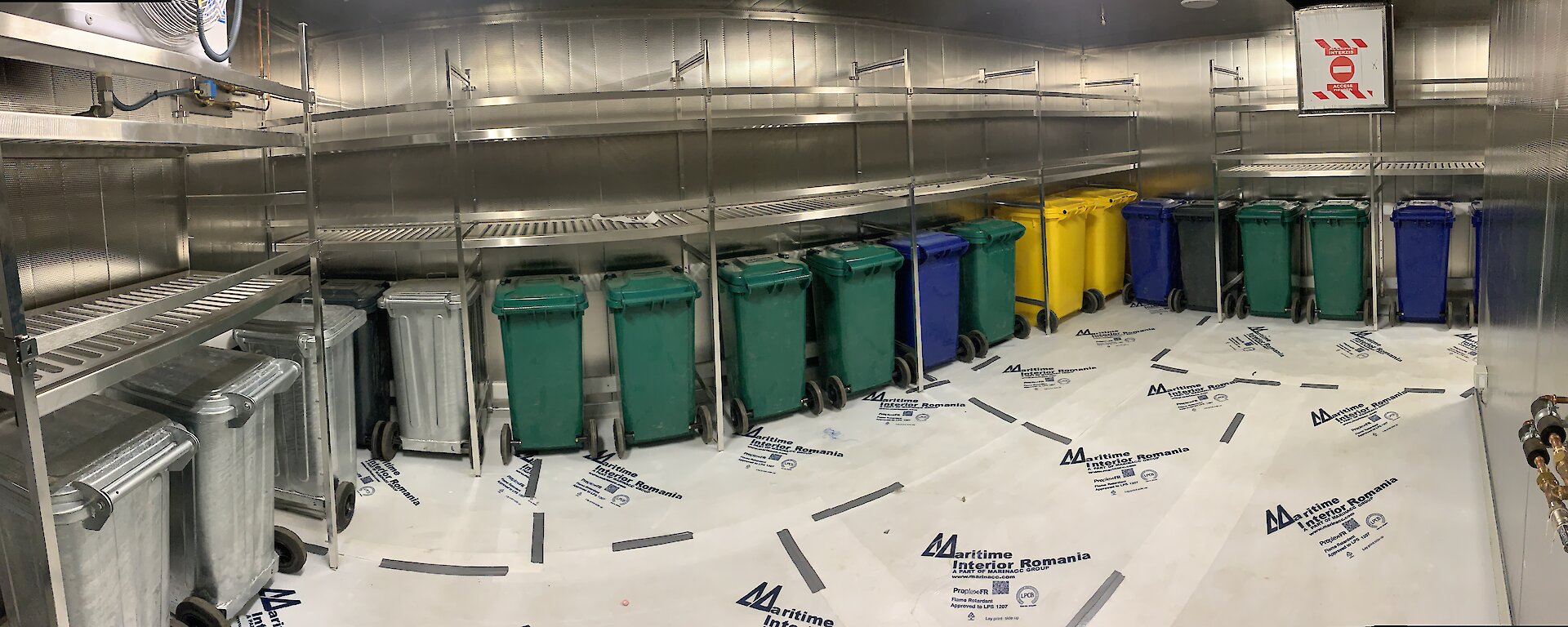 A line of coloured wheelie bins.