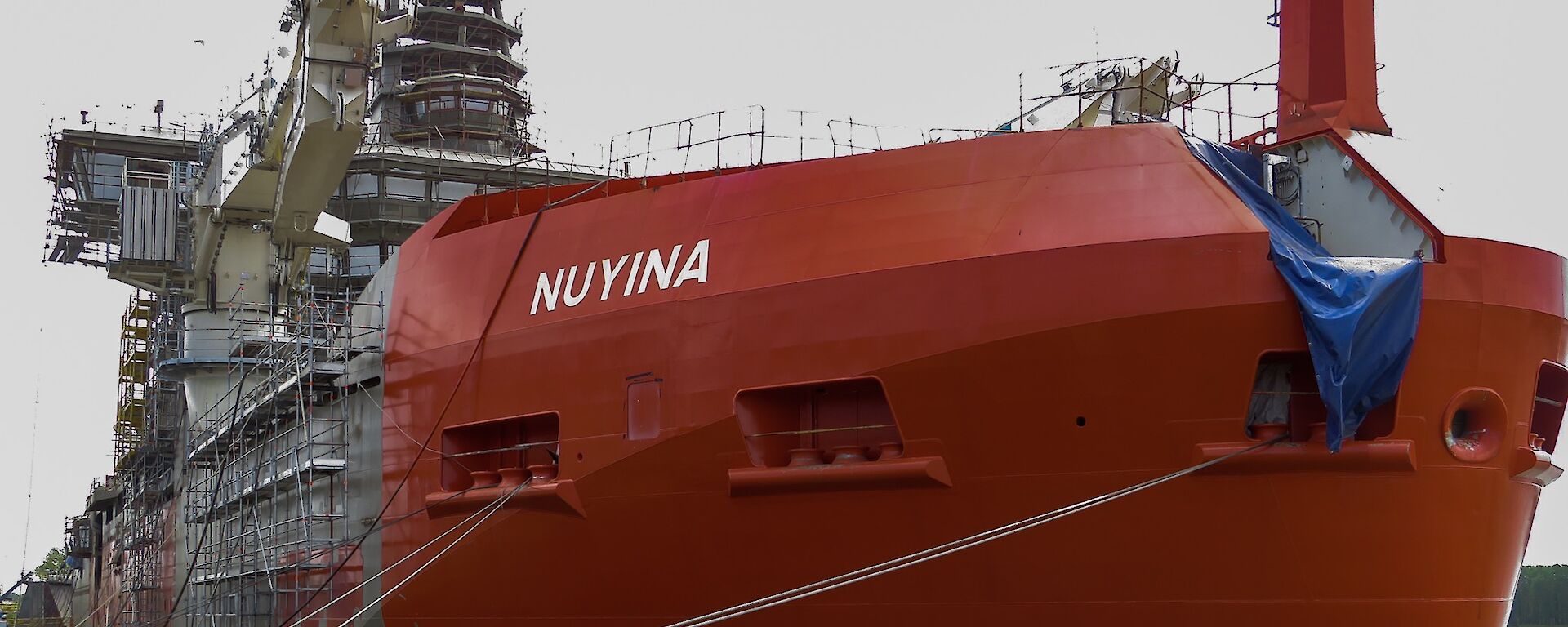 Bow view of Nuyina painted in international orange.
