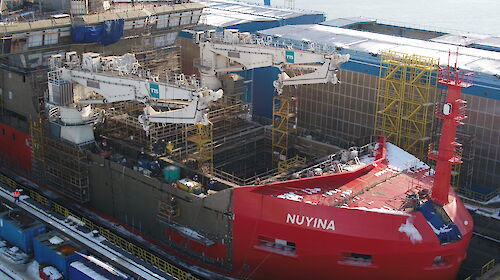 Nuyina in the dry dock with two cranes installed.