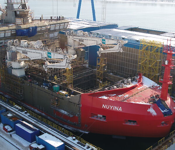 Nuyina in the dry dock with two cranes installed.