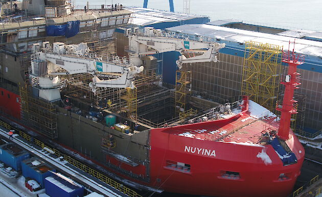 Nuyina in the dry dock with two cranes installed.