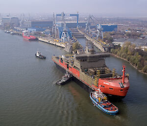 Aerial of Nuyina being backed into the wet dock at the Damen Shipyards.