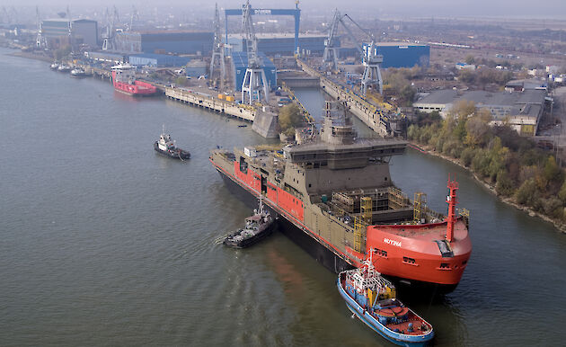 Aerial of Nuyina being backed into the wet dock at the Damen Shipyards.