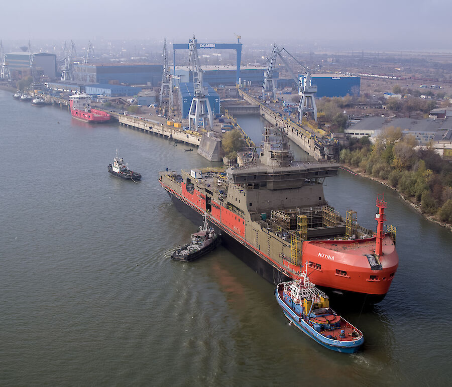 Aerial of Nuyina being backed into the wet dock at the Damen Shipyards.