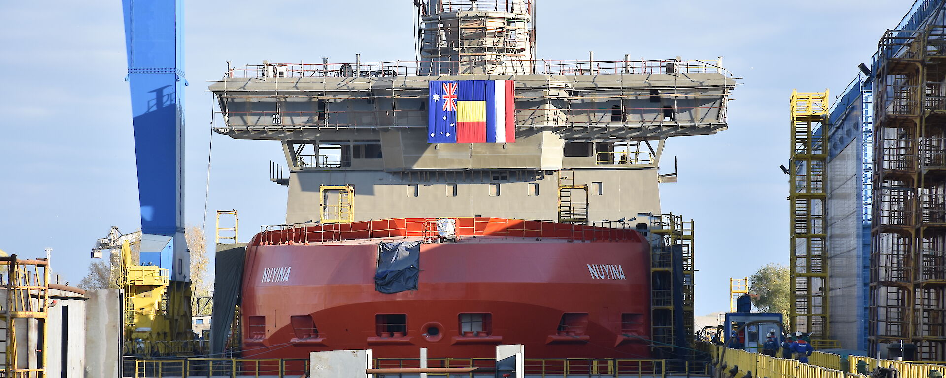 The Nuyina in the wet dock crowned with a crows nest, 32 metre-long navigation bridge and science observation deck.