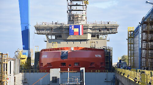 The Nuyina in the wet dock crowned with a crows nest, 32 metre-long navigation bridge and science observation deck.