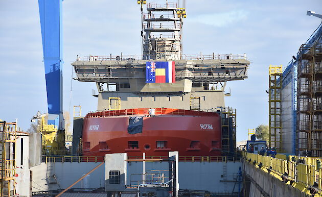 The Nuyina in the wet dock crowned with a crows nest, 32 metre-long navigation bridge and science observation deck.