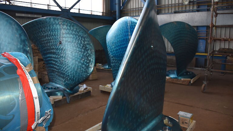 The blades of the ship’s propellers covered in a blue protective coating