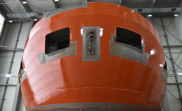 A section of the new ship painted in International Orange.