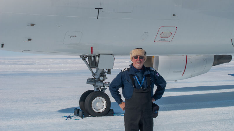 Man standing in front of aeroplane on ice