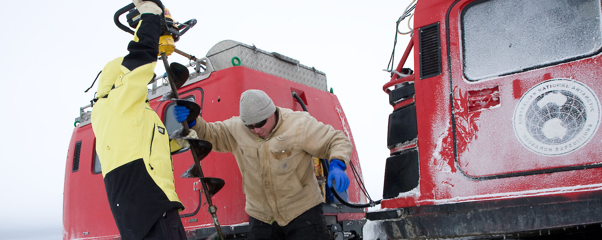 Kym Newbery using an ice drill in Antarctica