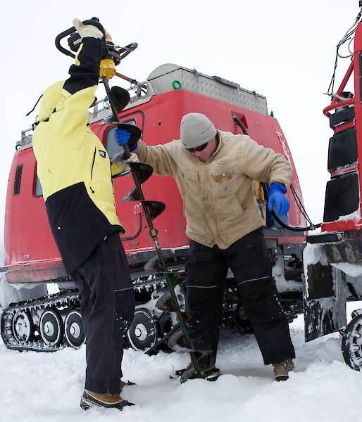 Kym Newbery using an ice drill in Antarctica