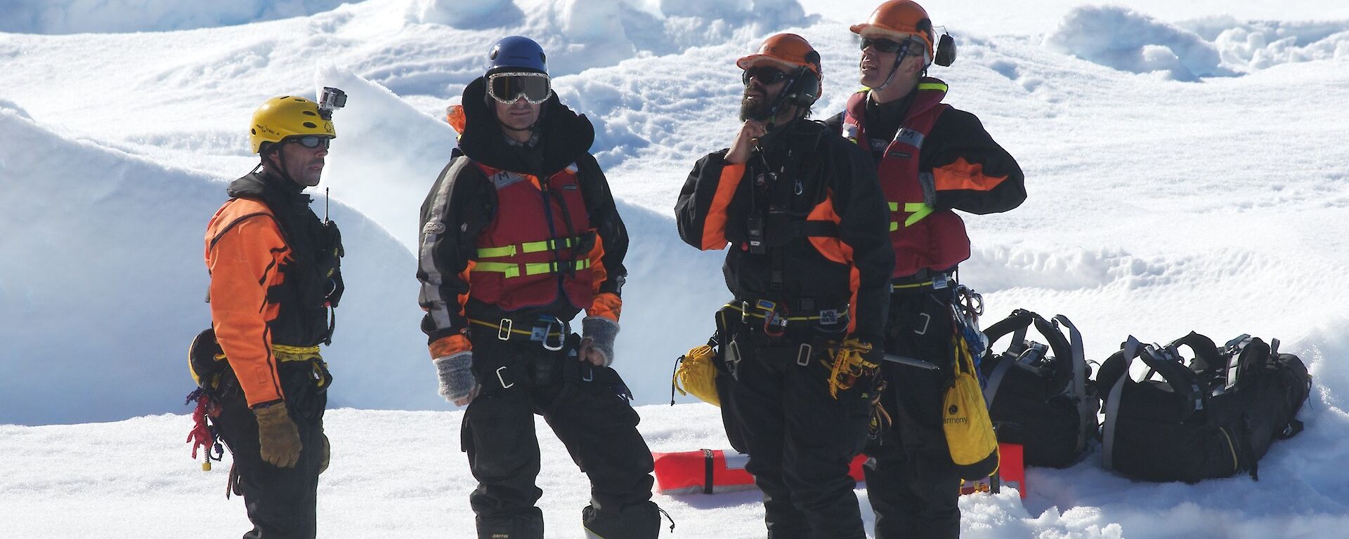 Rescue team preparing landing spot on the ice for the helicopter