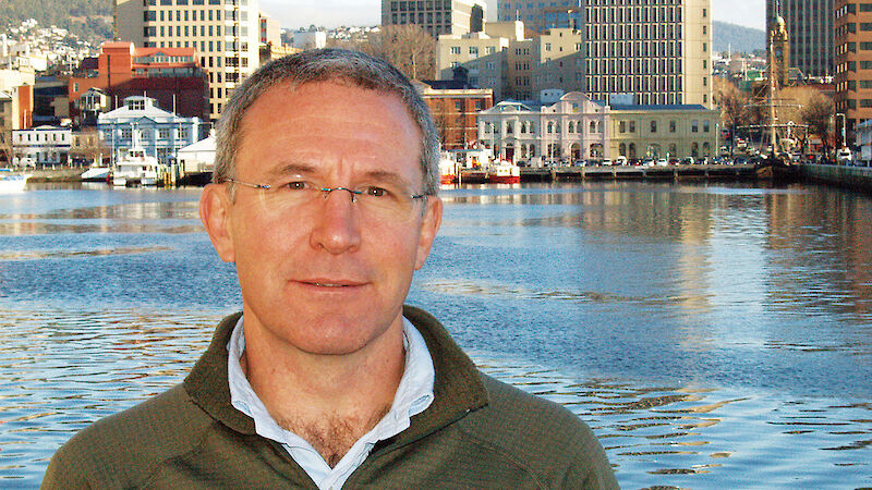 Portrait of scientist with view of port of Hobart behind