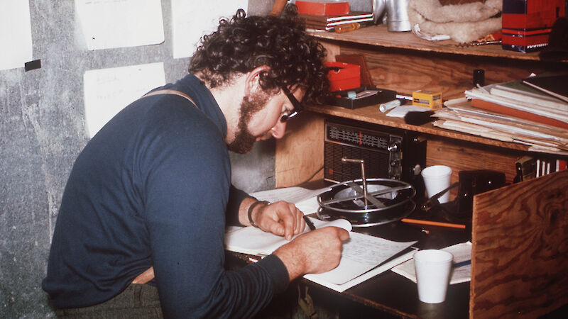 Scientist writing at desk