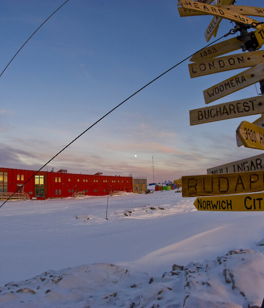A sign showing the distance and direction to major cities around the world.