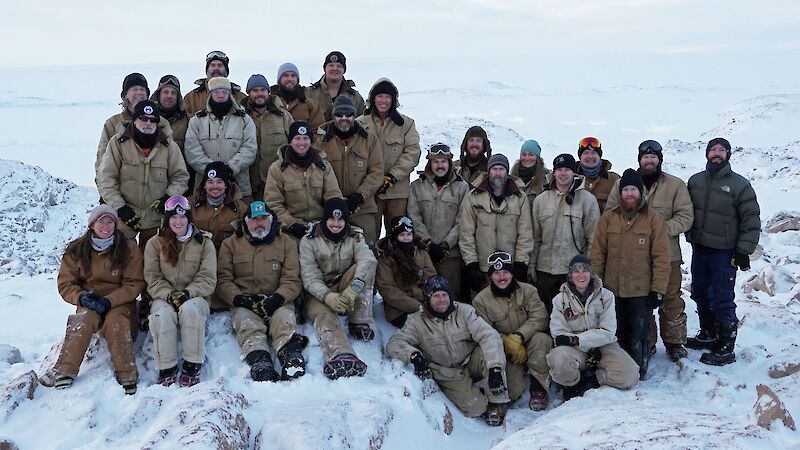 Large group of expeditioners posing for photo in tradeswear.