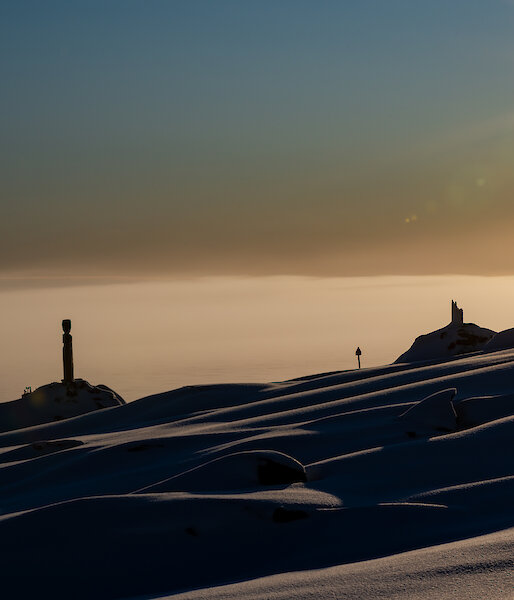Sculptures silhouetted by the sun.