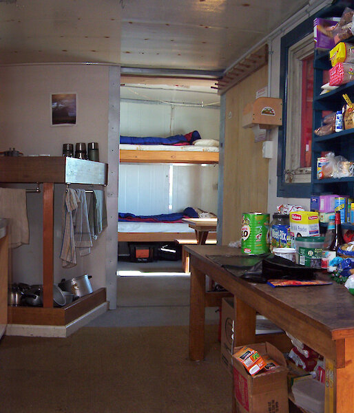 Internal shot of hut — food shelves, cooking facilities & bunks